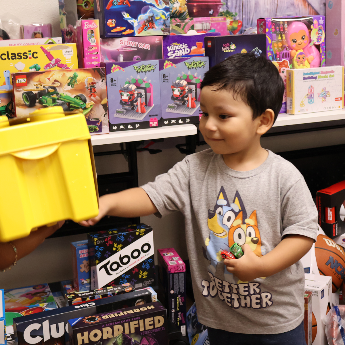A child picks out a toy at SAY San Diego's Holiday Hopes toy shop